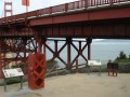 Much of what you need to know about the seismic features of the Golden gate bridge can be learnt just next to the bridge. While difficult to identify from this photo, you can see three seismic pads just under the bridge deck and on the supports